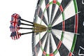 Metal darts have hit the red bullseye on a dart board. Darts Game. Darts arrow in the target center darts in bull`s eye close up. Royalty Free Stock Photo