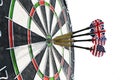 Metal darts have hit the red bullseye on a dart board. Darts Game. Darts arrow in the target center darts in bull`s eye close up. Royalty Free Stock Photo