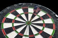 Metal darts have hit the red bullseye on a dart board. Darts Game. Darts arrow in the target center darts in bull`s eye close up. Royalty Free Stock Photo