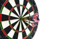 Metal darts have hit the red bullseye on a dart board. Darts Game. Darts arrow in the target center darts in bull`s eye close up Royalty Free Stock Photo