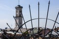 Metal decorative grid. The blurred tower of the Lviv Town Hall in the style of classicism in the background