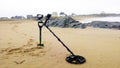 metal detector at the beach on the sand
