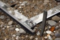 metal detector frame with close-up of the ground, showing broken glass and coins