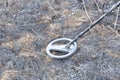 Metal detector. Search for metal artifacts on a field with damaged grass