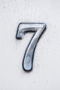 Metal digit - 7 on wooden background Royalty Free Stock Photo