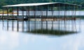 Metal boat dock reflecting on the lake