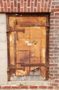 Rusted Iron Door in a Brick Wall Royalty Free Stock Photo