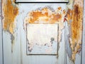 Metal door of building with rust and peeling cracked color paint background and texture Royalty Free Stock Photo