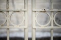 Metal door found at Odeon of Herodes Atticus entrance in Athens, Greece. Focus is on metal door, blurred theater in background