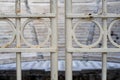 Metal door found at Odeon of Herodes Atticus entrance in Athens, Greece. Focus is on metal door, blurred theater in background