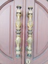 Metal door handle with beautiful carvings. Gold door handle with carved pattern.