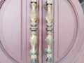Metal door handle with beautiful carvings. Gold door handle with carved pattern.