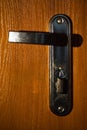Metal door handle with lock on wooden door Royalty Free Stock Photo