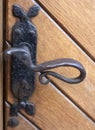 Metal door handle on a wooden door closeup Royalty Free Stock Photo