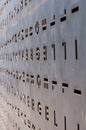 Metal door with the holes in the shape of letters