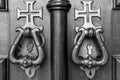 Metal Door Knockers on Wooden Door with Crosses