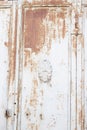 Metal door with rust, crack and old loose white paint texture Royalty Free Stock Photo