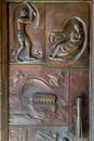 Metal door showing a fisherman, Noah`s Ark and Madonna and Chil Royalty Free Stock Photo