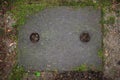 Metal drain cover in concrete path