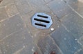 Metal drain in a medieval cobblestone street. Photographed in a hill town of Tuscany Italy.