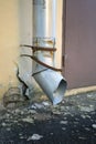 Metal drainpipe on shabby wall