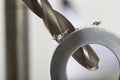 Metal drill bit make holes in aluminium pipe on industrial drilling machine. Metal work industry