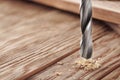 Metal drill bit make holes in a wooden board with expressive texture