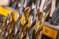 Metal drill bits placed in a stand. Accessories in a home workshop.