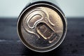 Metal drink can with water drops. Shiny cola can close-up. Golden bottle of beverage, lid of packaging of soda, tonic. Top view