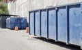 Metal durable blue industrial trash bin for outdoor trash at construction site. Large waste basket for household or industrial