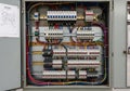 A metal electrical panel houses multiple circuit breakers arranged vertically and horizontally. Royalty Free Stock Photo