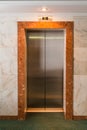 Metal Elevator doors in the lobby. Corridor in a hotel
