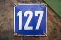 Metal enameled plate of number 127