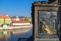 Metal engraving of a warrior with a dog with an old building on the background and river