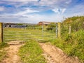 Metal gate across the entrance to an arable field in the Welsh countryside Royalty Free Stock Photo