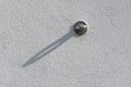 Metal eyelet screwed to building wall for hanging and tensioning outdoor advertising such as banners, flyers, posters with a