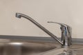 Metal faucet sink in modern kitchen. New home interior