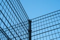 Metal fence on blue sky - metal grid construction Royalty Free Stock Photo