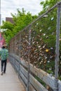 Metal fence covered in colorful locks on Locke Street in Hamilton