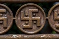 Metal fence detail with ancient swastika ornament Royalty Free Stock Photo