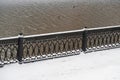 The metal fence of the Drainage Canal and the footpath are covered with snow, dark water surface, minimalism, geometry, Moscow,