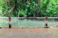 Metal fence for flooding over the road at national park waterfall