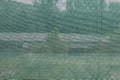 Metal fence with a green plastic mesh to not let see through Royalty Free Stock Photo