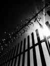 A metal fence keeping trespassers out with a warning sign stating danger of death