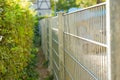 Metal fence and natural fencing. Natural fencing and metal fence.