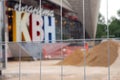 Metal fence net against blurred background of KVN club logo in Moscow