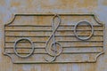 Metal fence of the old music school with decorative symbols in the form of a treble clef and notes on the stave