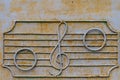 Metal fence of the old music school with decorative symbols in the form of a treble clef and notes on the stave