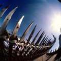 Metal fence with sharp spikes against blue sky Royalty Free Stock Photo