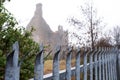 Metal fence with spikes in focus. remains of Terryland castle out of focus in the background. Galway city, Ireland. Historical